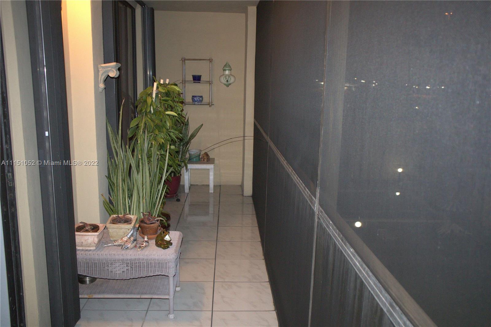 8625 Northwest 8th Street, Unit 420 Miami, FL 33126 - Photo 24 of 26 a room with window and stairs