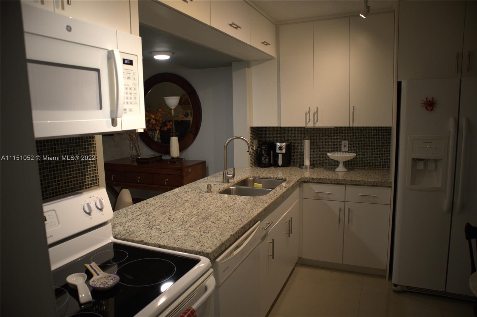 8625 Northwest 8th Street, Unit 420 Miami, FL 33126 - Photo 7 of 26 a kitchen with a stove and a sink