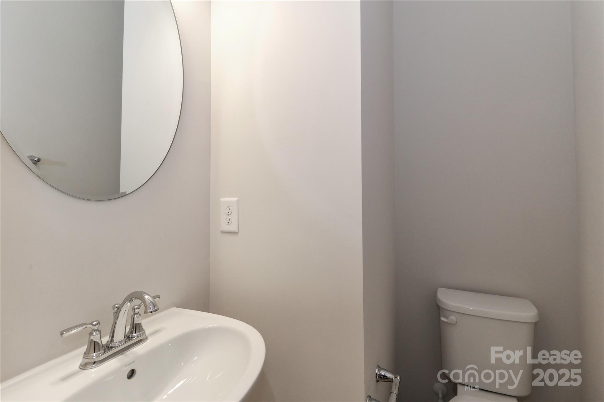 5038 Springarn Court Charlotte, NC 28208 - Photo 15 of 47 a bathroom with a sink and a mirror