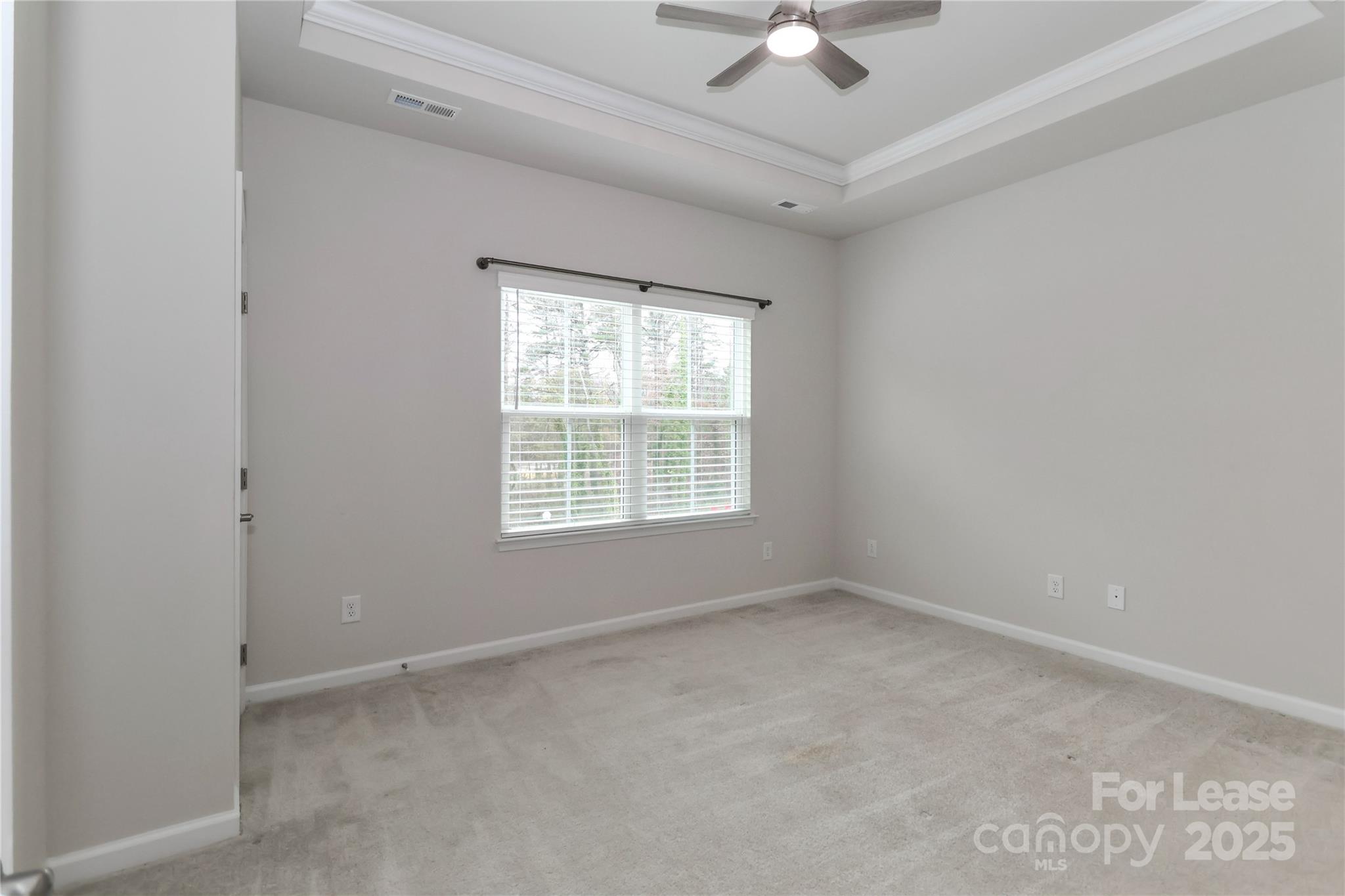 5038 Springarn Court Charlotte, NC 28208 - Photo 21 of 47 an empty room with a ceiling fan and window