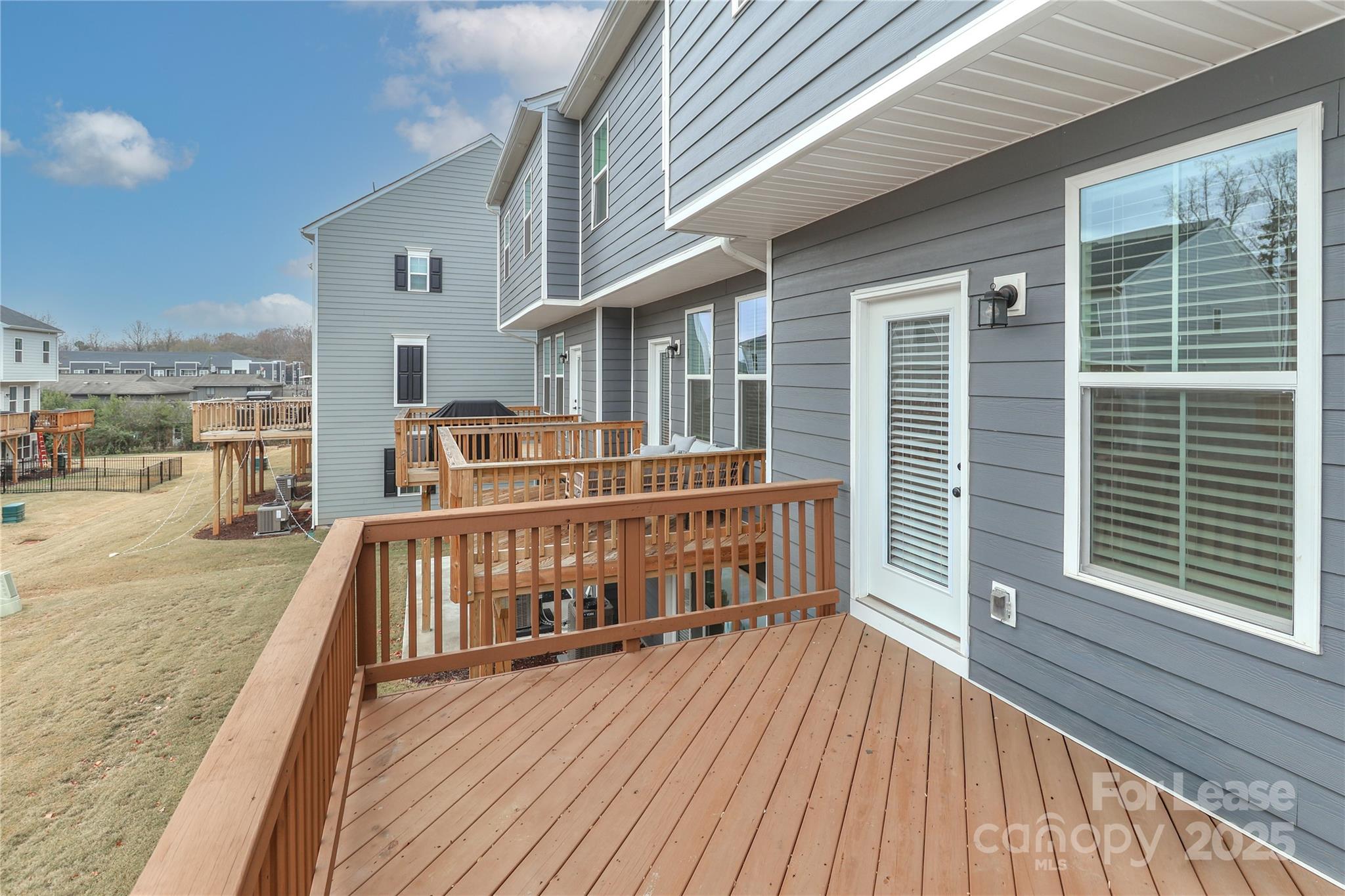 5038 Springarn Court Charlotte, NC 28208 - Photo 37 of 47 a view of a balcony with two chairs and wooden floor