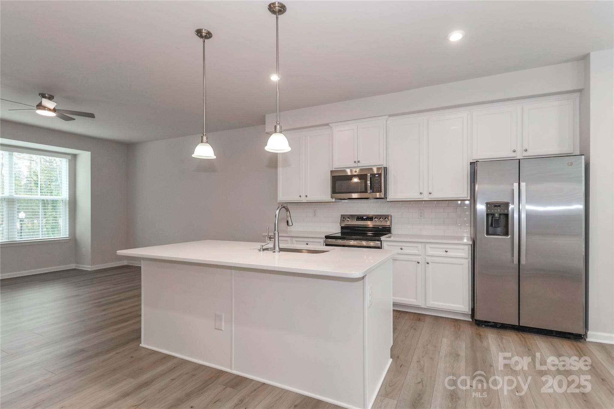 5038 Springarn Court Charlotte, NC 28208 - Photo 5 of 47 a kitchen with stainless steel appliances granite countertop a sink a stove a refrigerator and island with wooden floor