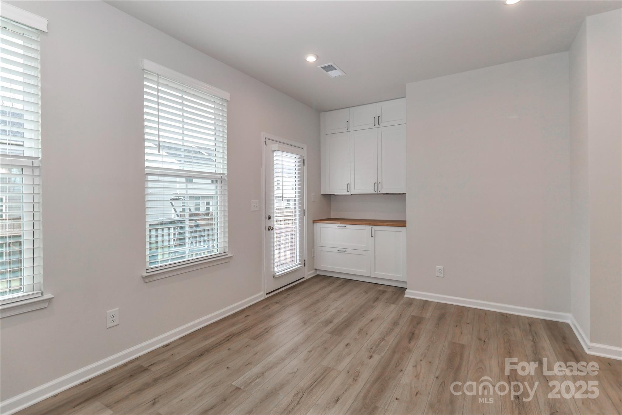5038 Springarn Court Charlotte, NC 28208 - Photo 9 of 47 a view of wooden floor and windows in a room