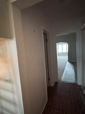 a bathroom with a light fixture and a shower