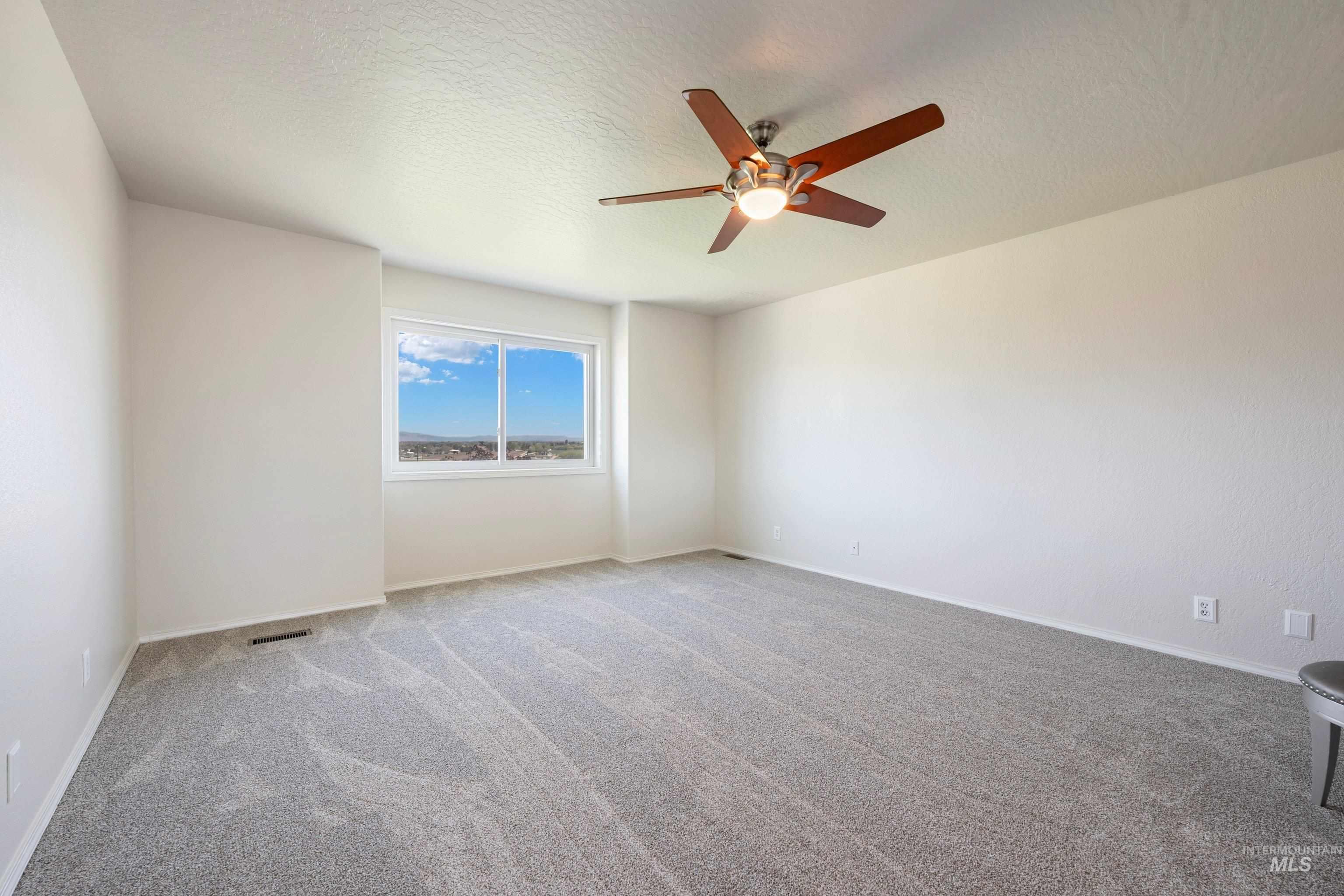 7657 Track Road Nampa, ID 83686 - Photo 23 of 49 Spacious room featuring neutral carpeting and a ceiling fan with integrated lighting