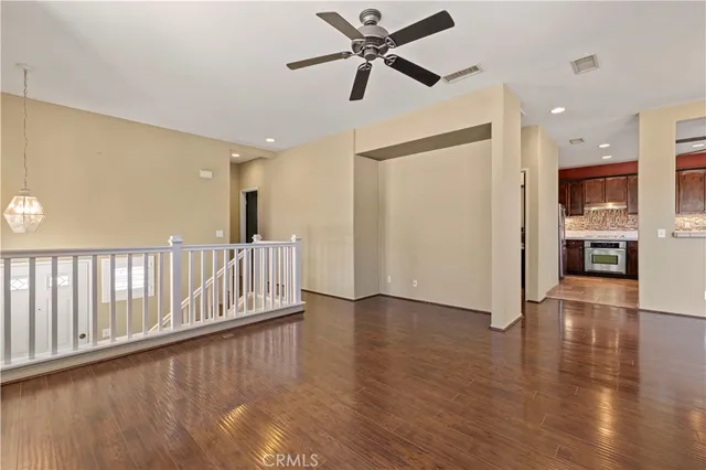 a view of a livingroom with a hardwood floor and a ceiling fan