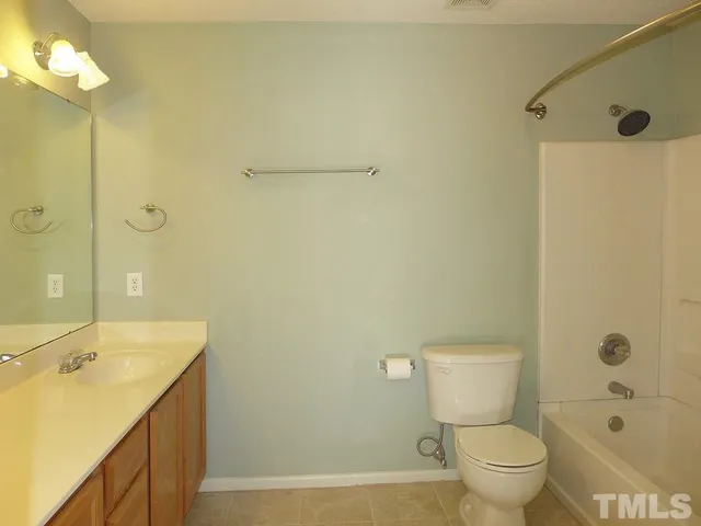 a bathroom with a granite countertop sink a toilet and shower