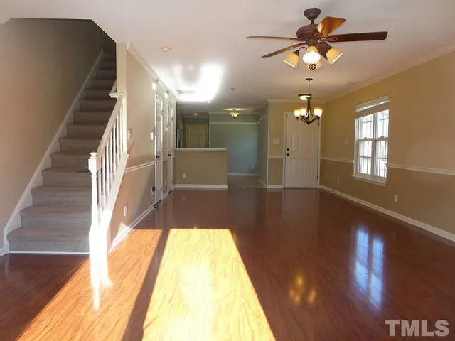 a view of entryway and hall with wooden floor