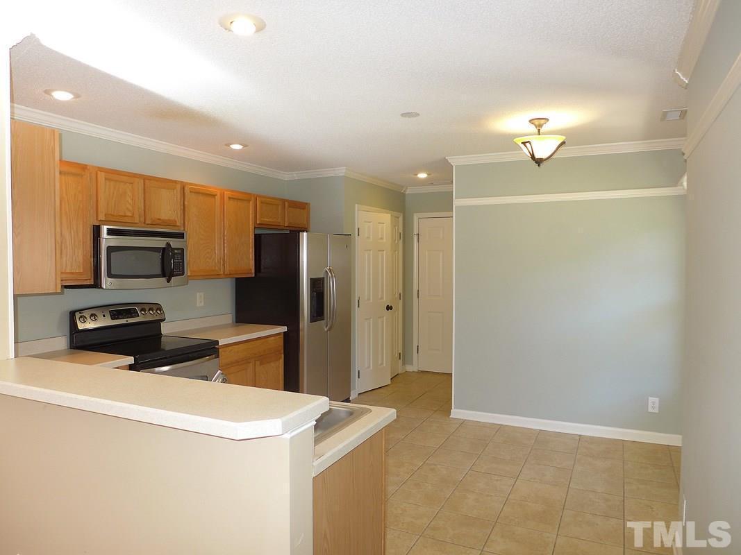 122 Higher Learning Drive Durham, NC 27713 - Photo 5 of 19 a kitchen with a refrigerator a stove top oven a sink and dishwasher