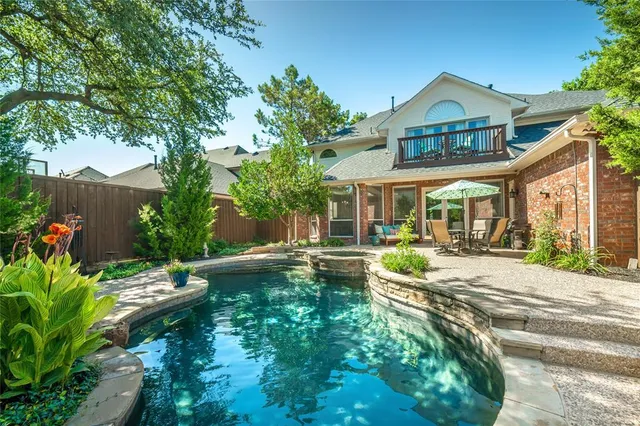 a view of a house with garden and sitting area