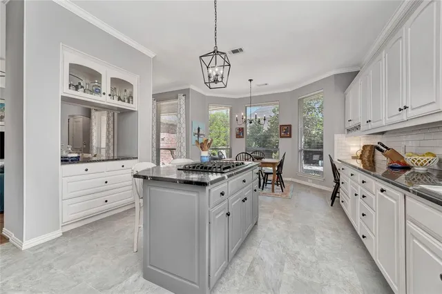 a kitchen with stainless steel appliances a stove sink cabinets and refrigerator