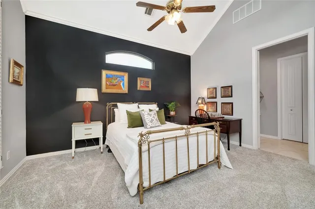 a bedroom with furniture and a large window