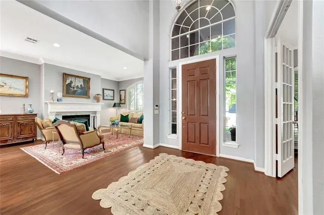 a living room with furniture a fireplace and wooden floor