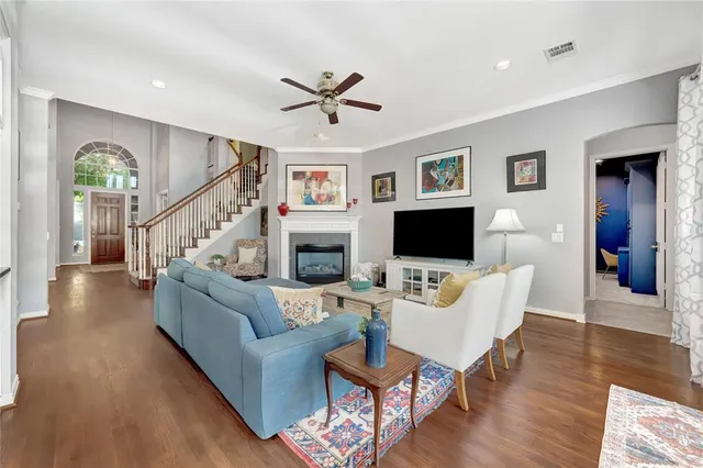 a living room with furniture flat screen tv and a fireplace