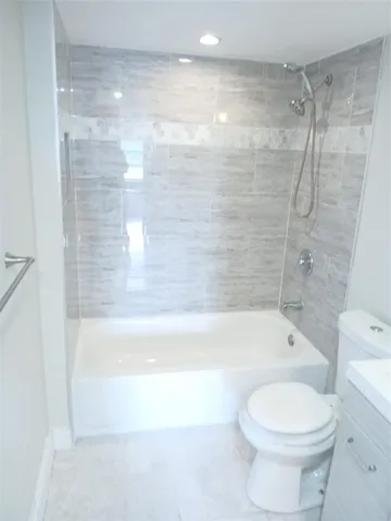 a bathroom with a bathtub and a toilet