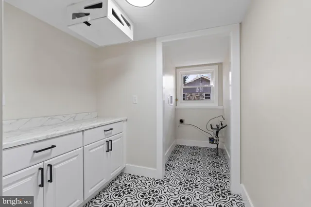 a hallway with a baby crib and dresser