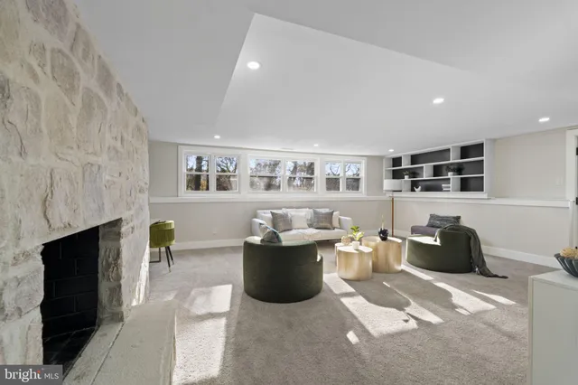 a living room with furniture and a fireplace