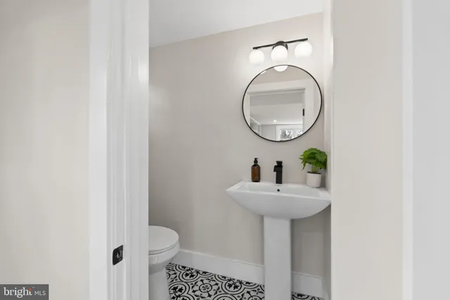 a bathroom with a sink a mirror and a window