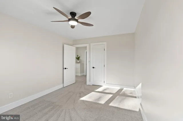 a view of a big room with wooden floor and a ceiling fan