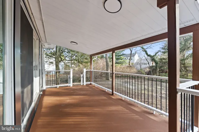 a view of a room with wooden floor and windows