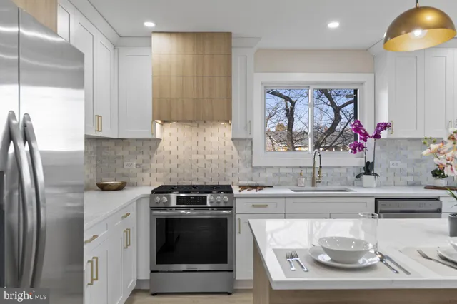a kitchen with stainless steel appliances granite countertop a sink and cabinets