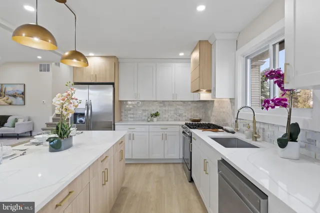 a kitchen with a sink a stove and cabinets
