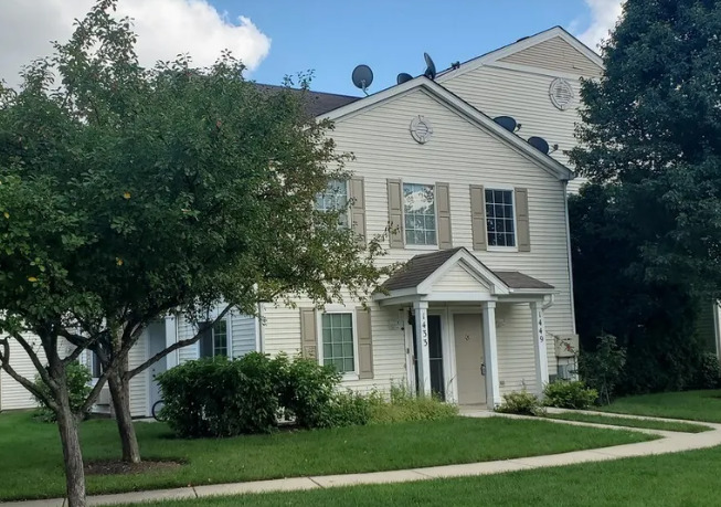 1449 McClure Road, Unit 1449 Aurora, IL 60505 - Photo 1 of 25 a front view of a house with a yard