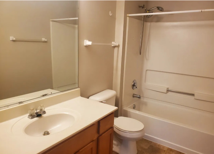 1449 McClure Road, Unit 1449 Aurora, IL 60505 - Photo 12 of 25 a bathroom with a sink toilet and shower