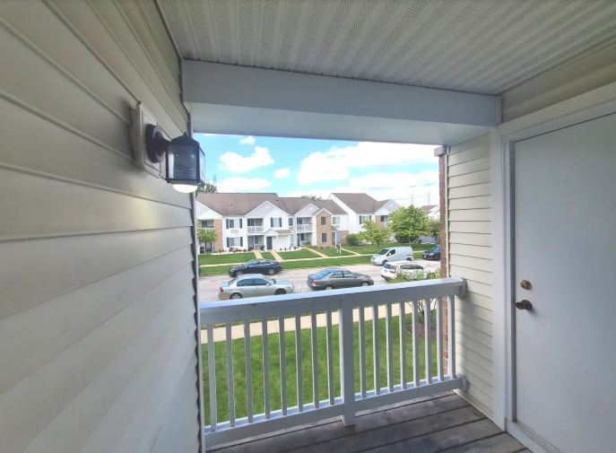 1449 McClure Road, Unit 1449 Aurora, IL 60505 - Photo 24 of 25 a view of a balcony with wooden floor