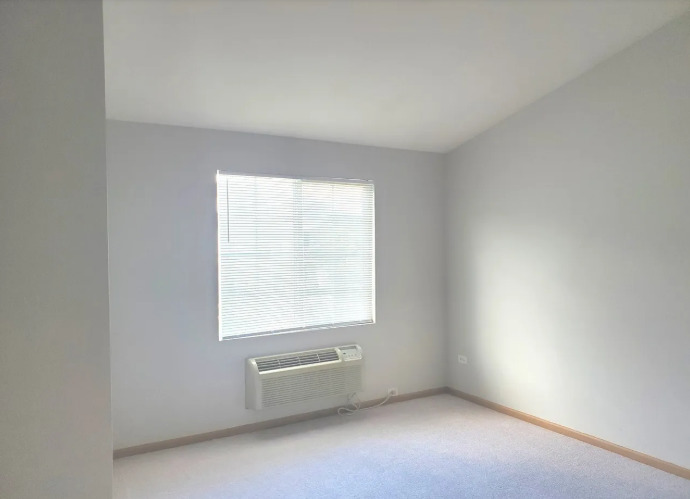 1449 McClure Road, Unit 1449 Aurora, IL 60505 - Photo 6 of 25 an empty room with a window