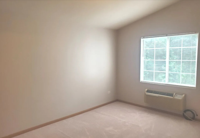 1449 McClure Road, Unit 1449 Aurora, IL 60505 - Photo 9 of 25 a view of an empty room with a window