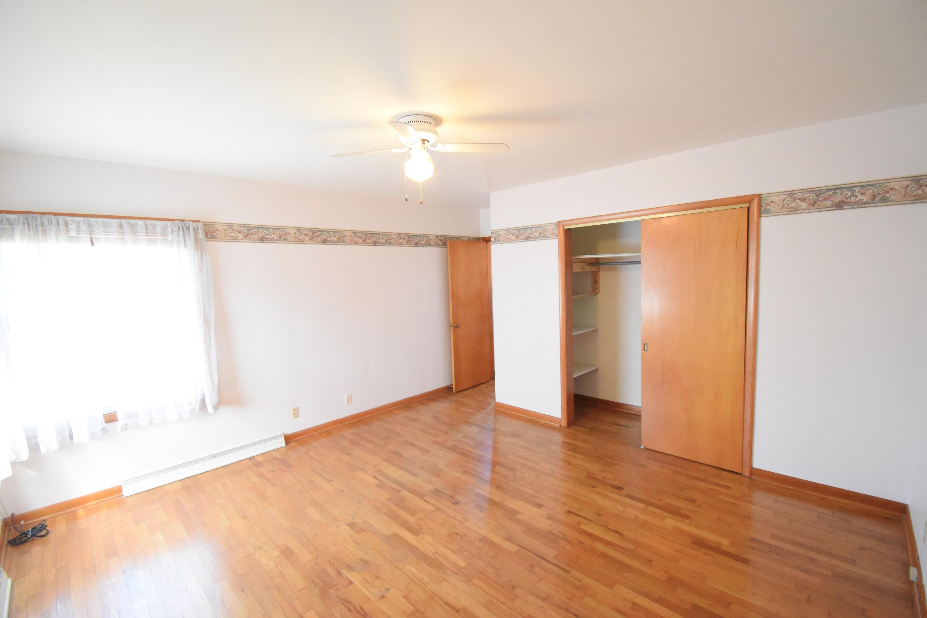 328 South Weston Street Rensselaer, IN 47978 - Photo 23 of 39 a view of an empty room with wooden floor and a window