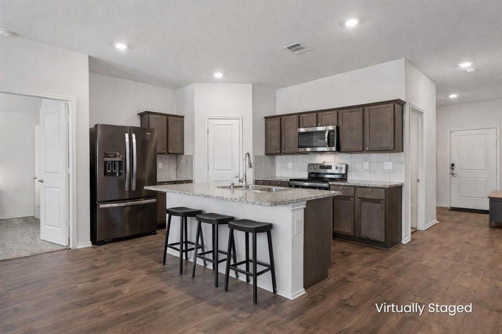 705 Windmill Street Royse City, TX 75189 - Photo 2 of 20 This kitchen with granite counters and stainless steal appliances showcases so much counter and cabinet storage!
