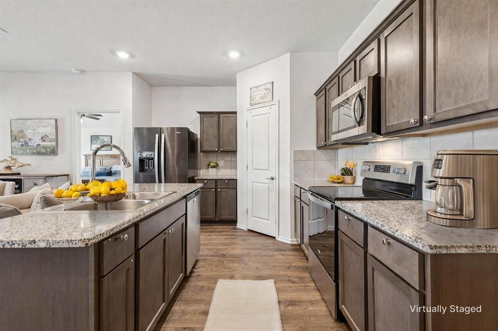 705 Windmill Street Royse City, TX 75189 - Photo 7 of 20 This kitchen with granite counters and stainless steal appliances showcases so much counter and cabinet storage!