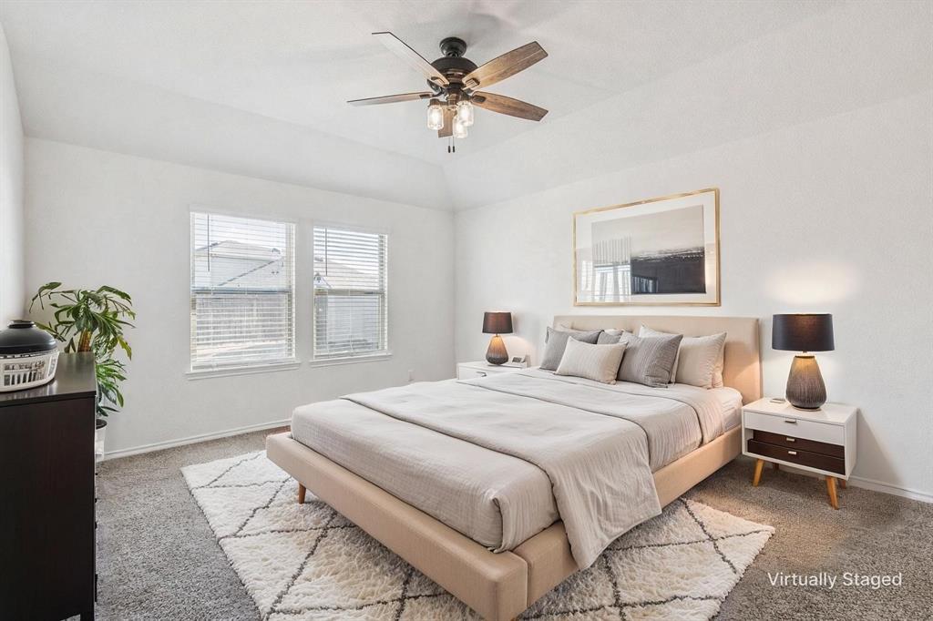 705 Windmill Street Royse City, TX 75189 - Photo 8 of 20 Owner's retreat is tucked away in the back of the home overlooking the backyard with an ensuite bath.