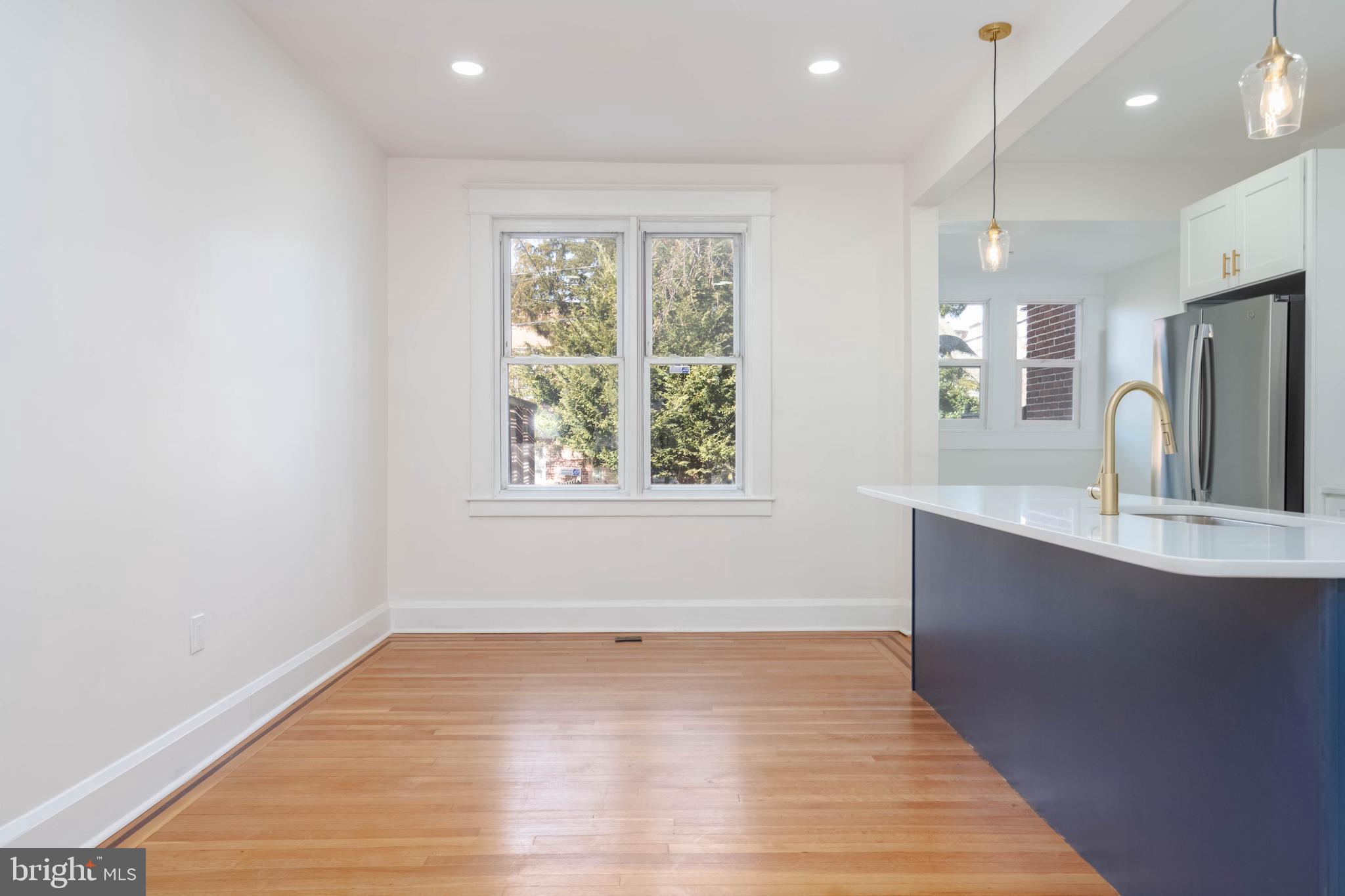 1202 West 42nd Street Baltimore, MD 21211 - Photo 14 of 47 an empty room with wooden floor and windows