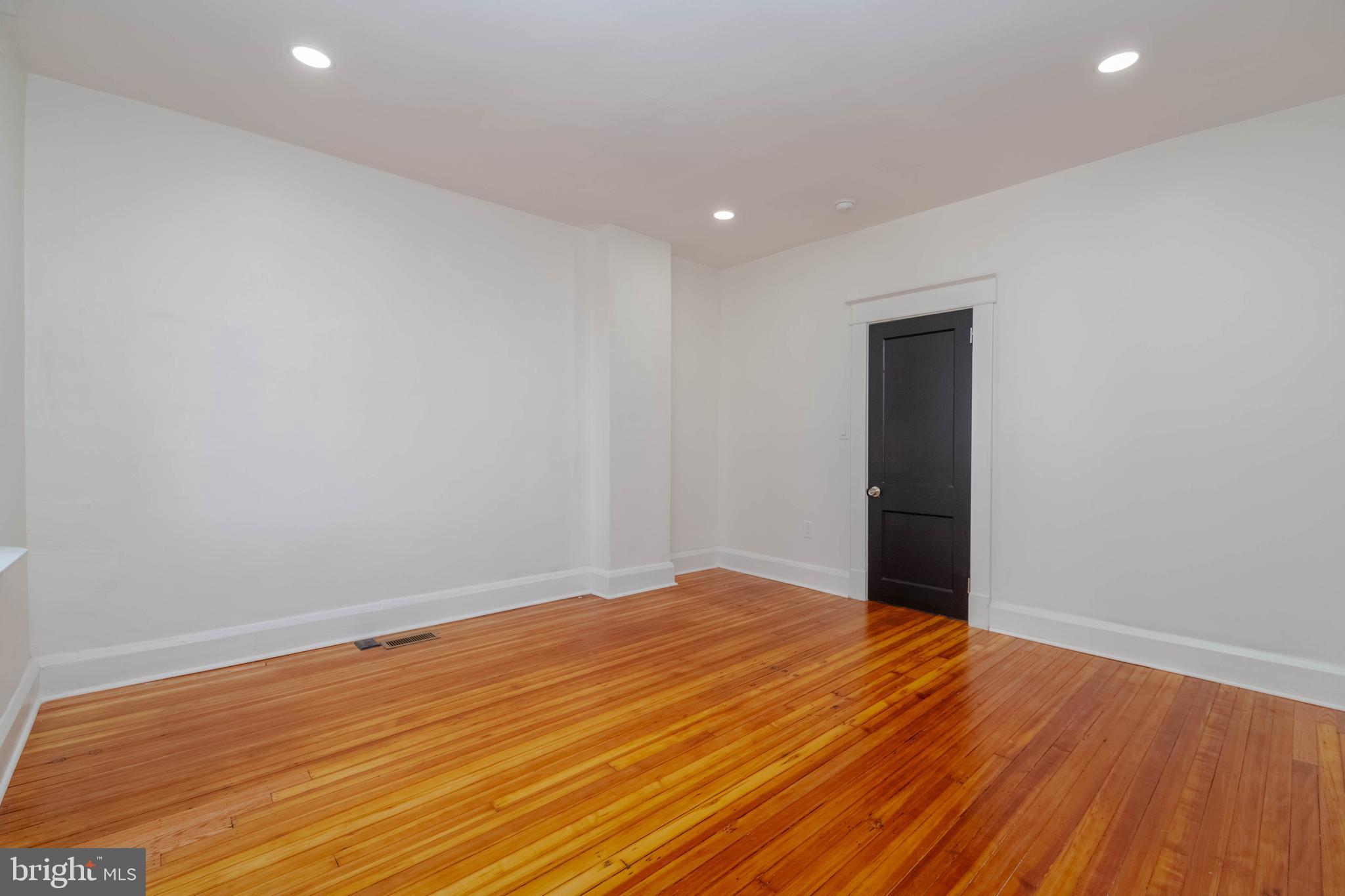 1202 West 42nd Street Baltimore, MD 21211 - Photo 19 of 47 a view of an empty room with wooden floor and closet