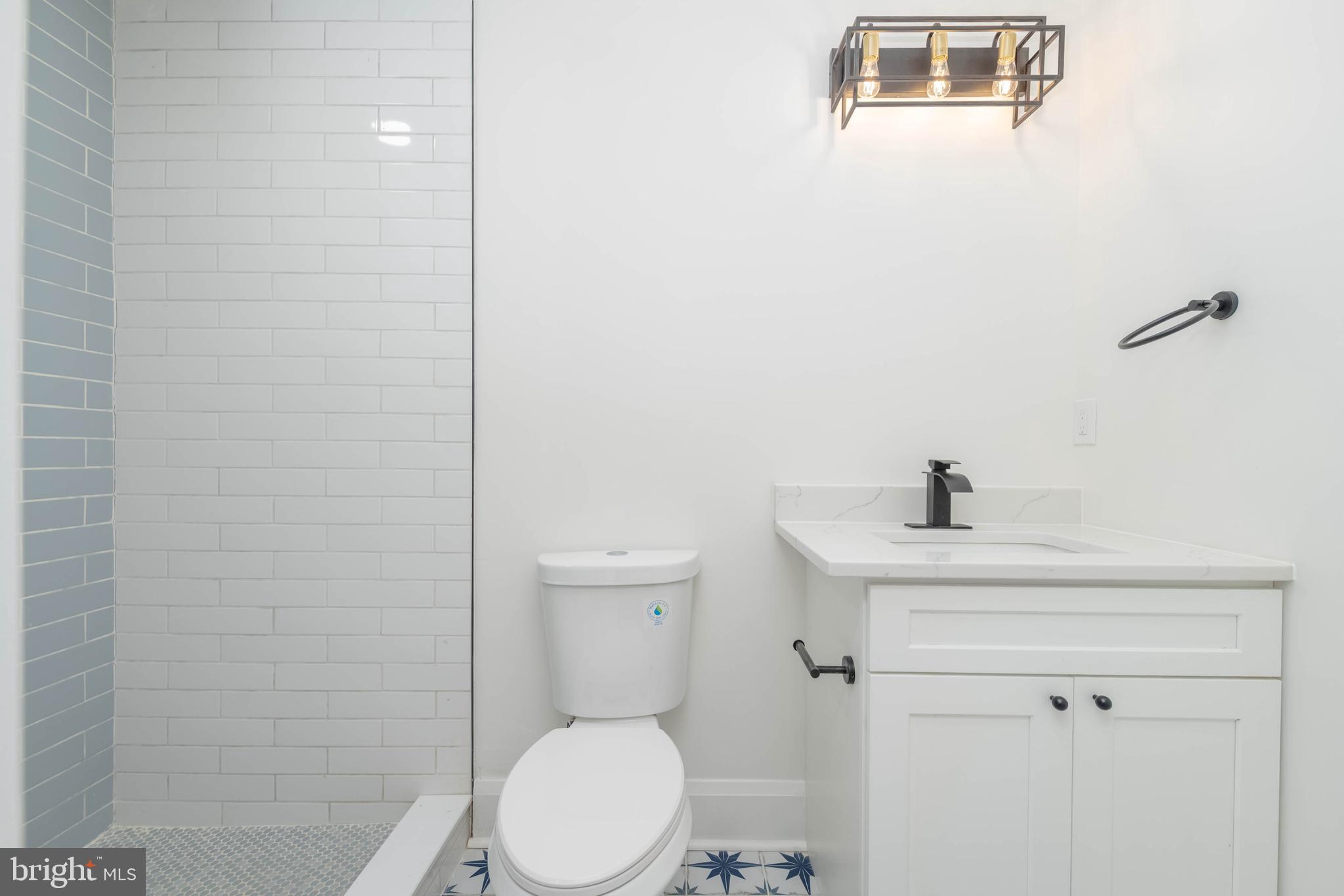 1202 West 42nd Street Baltimore, MD 21211 - Photo 20 of 47 a white toilet sitting next to a bathroom sink