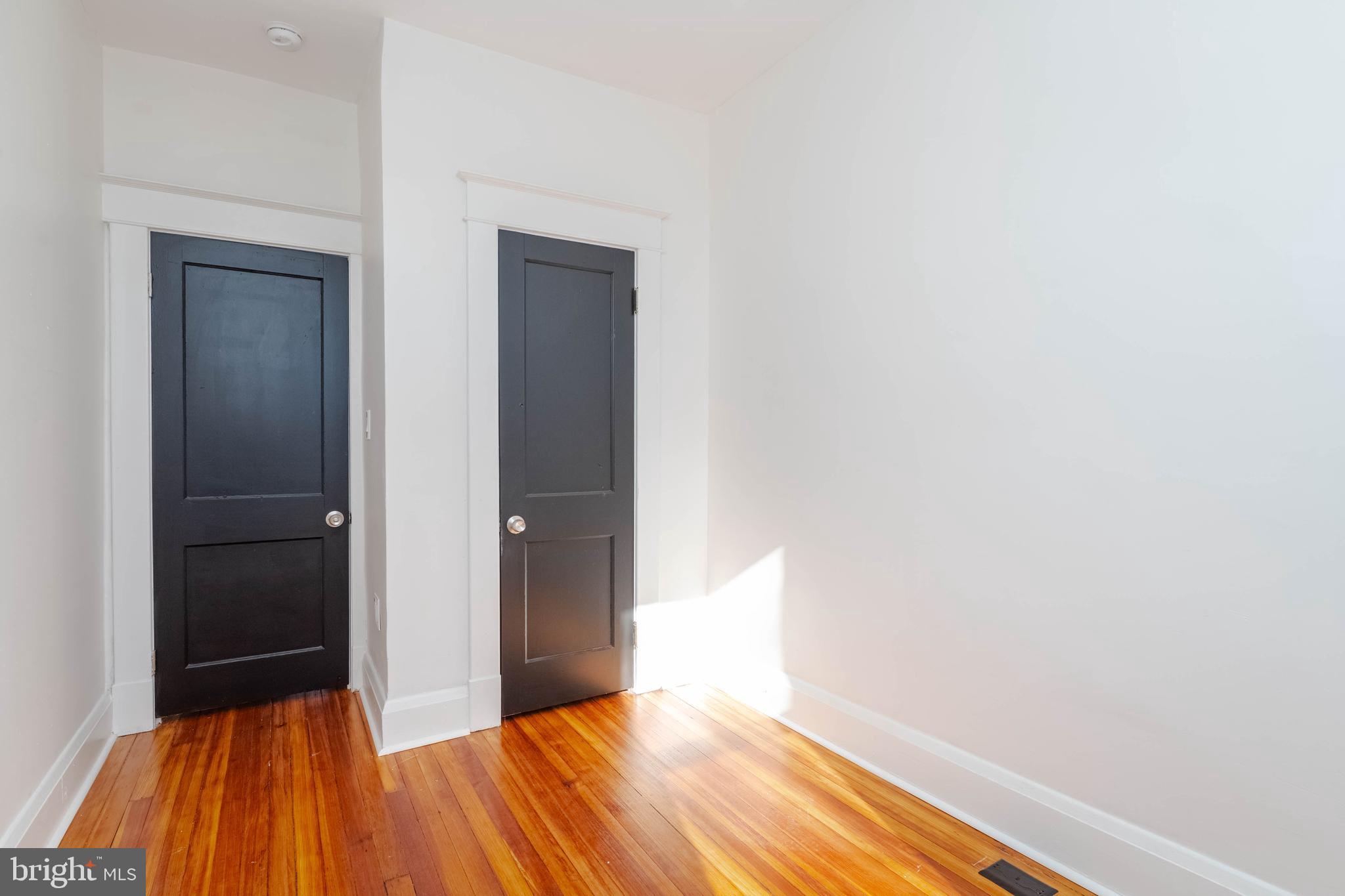 1202 West 42nd Street Baltimore, MD 21211 - Photo 29 of 47 a view of a room with wooden floor and a carpet