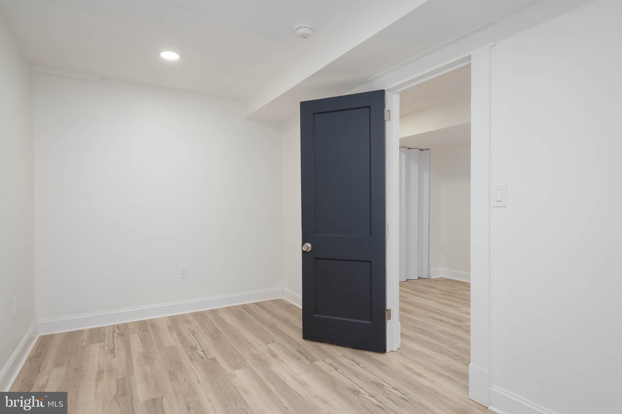 1202 West 42nd Street Baltimore, MD 21211 - Photo 36 of 47 a view of hallway with wooden floor