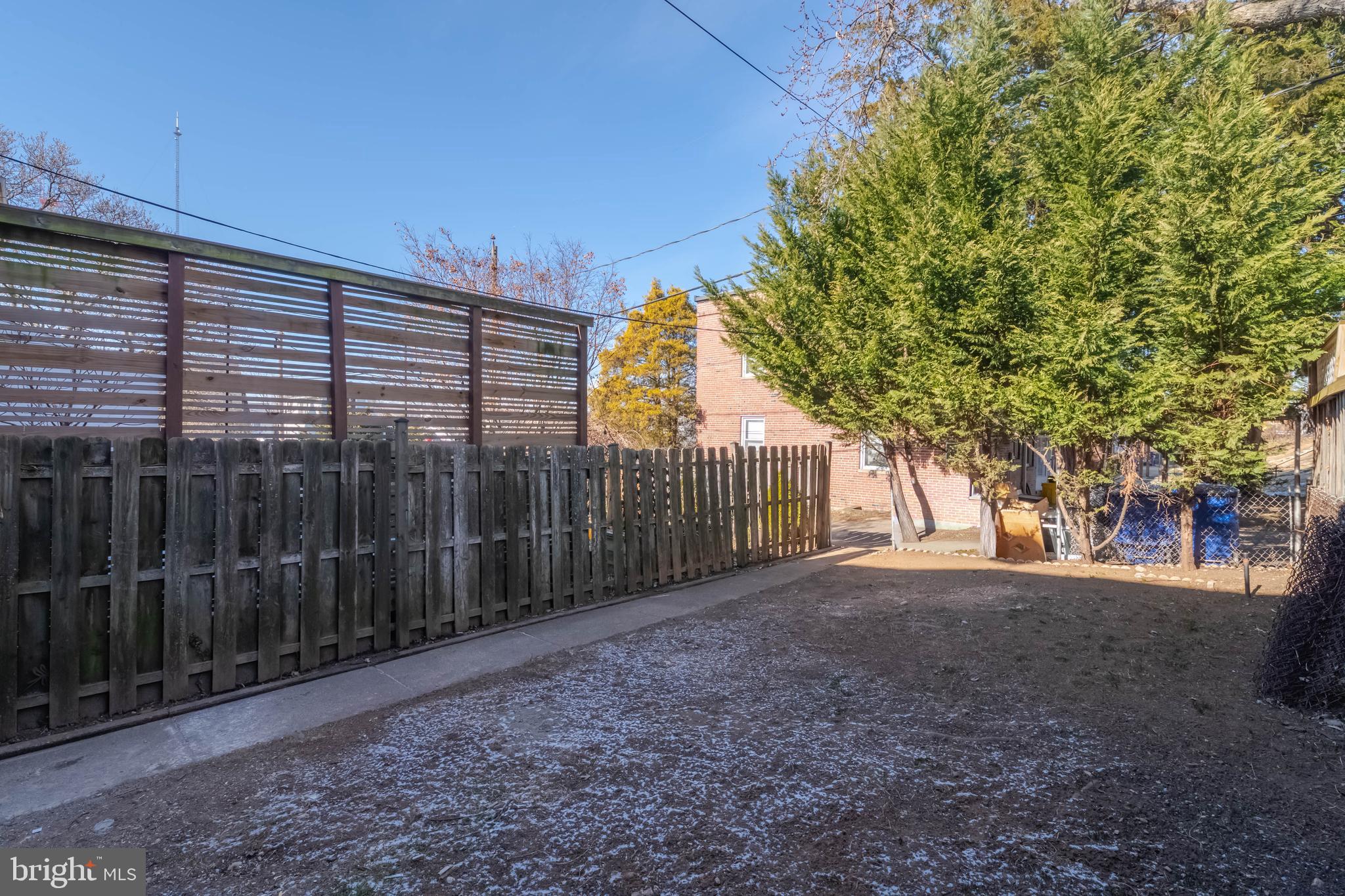 1202 West 42nd Street Baltimore, MD 21211 - Photo 45 of 47 a view of a backyard with brick wall and floor to ceiling window