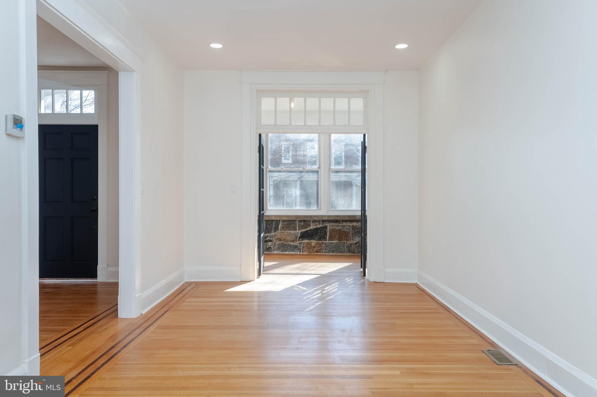 1202 West 42nd Street Baltimore, MD 21211 - Photo 5 of 47 a view of an empty room with wooden floor and a window