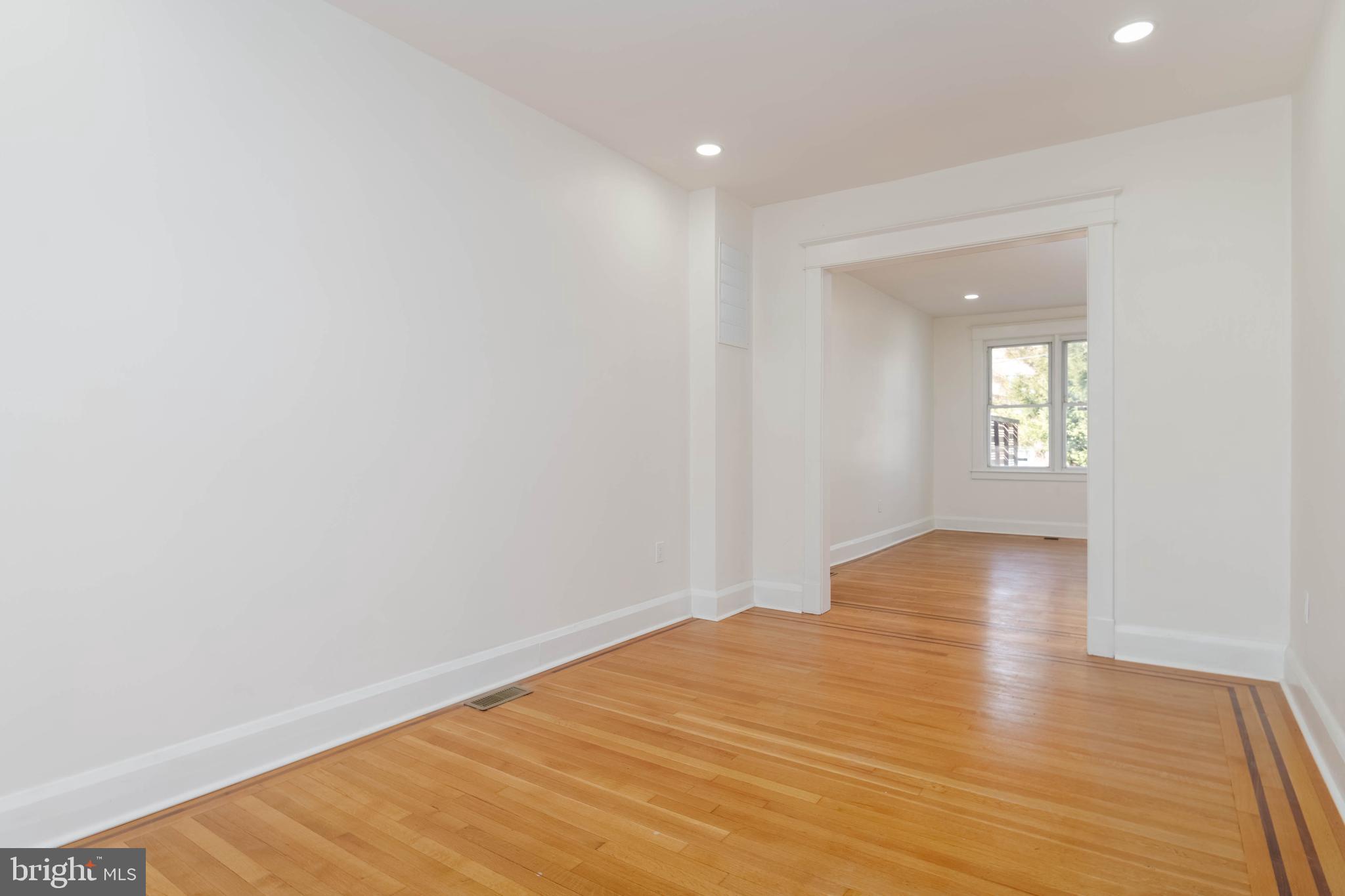 1202 West 42nd Street Baltimore, MD 21211 - Photo 7 of 47 a view of empty room with wooden floor and fan