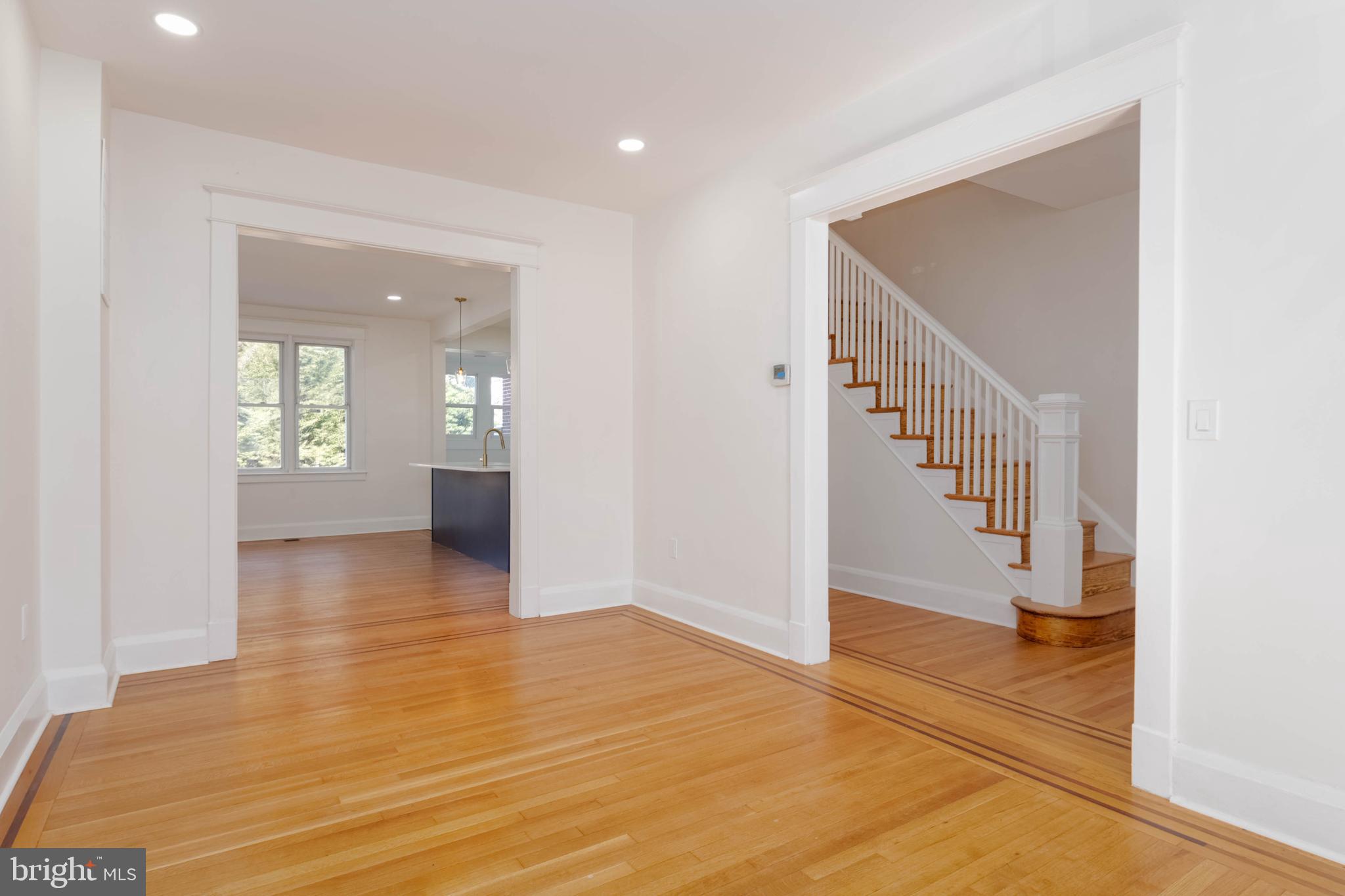 1202 West 42nd Street Baltimore, MD 21211 - Photo 8 of 47 a view of a hallway view with wooden floor and staircase