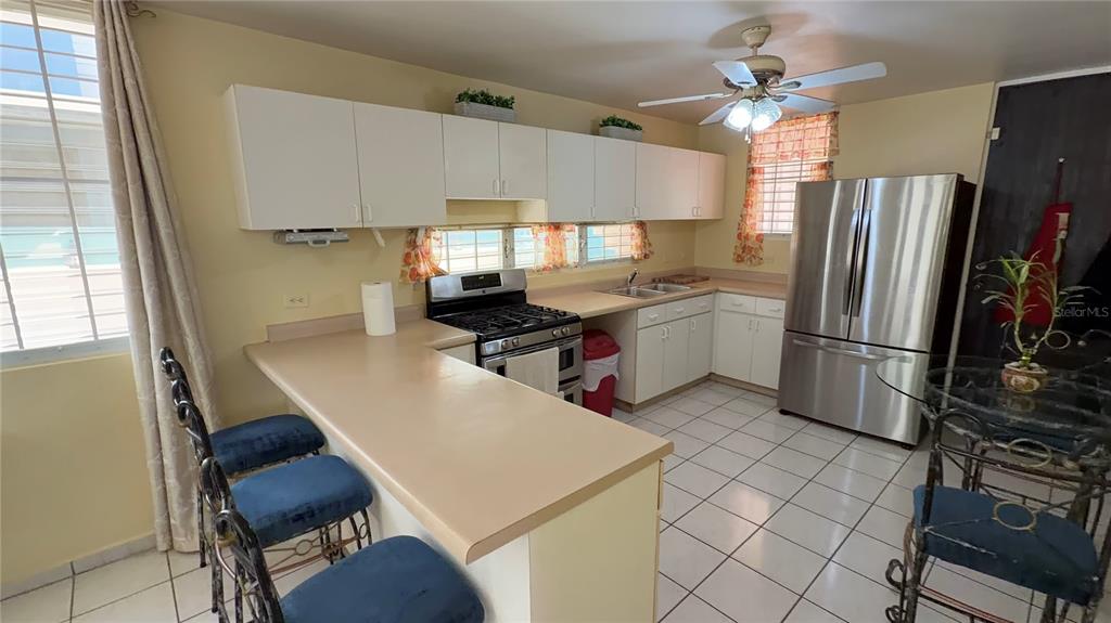 1 St Rio Grande, Unit B6 Rio Grande, PR 00745 - Photo 37 of 47 a kitchen with a sink appliances and cabinets
