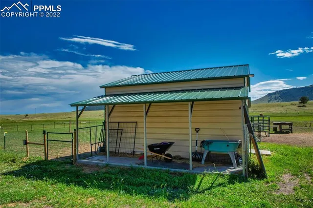 a view of a chair and table in the back yard