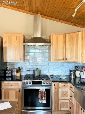 a kitchen with stainless steel appliances a stove a sink and a microwave