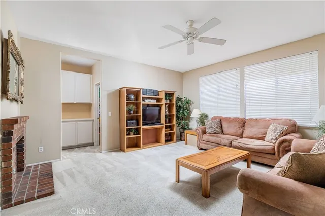 a living room with furniture and ceiling fan