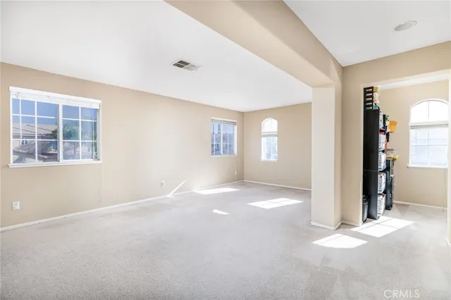 a bedroom with a bed window and a flat screen tv