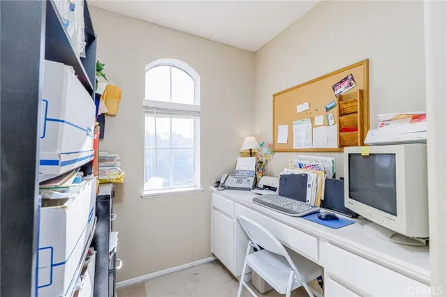 a bedroom with a bed a large mirror and a flat tv screen on the dresser